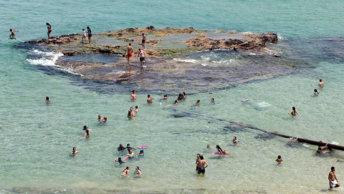 People beat the heat at Port Kembla beach on January 7, when the mercury climbed to 41.3 degrees at Albion Park. The Illawarra is in for a heatwave this weekend, although temps won't be as hot as earlier this month. Picture: Sylvia Liber