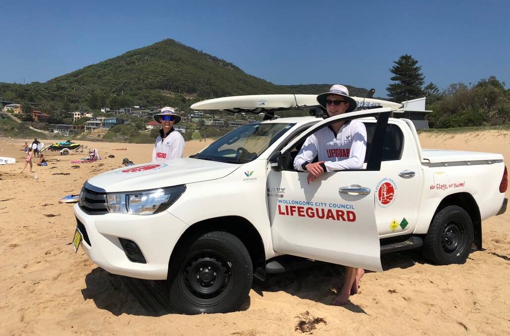 Wollongong City Council lifeguards Luke Essenstam (left) and Harry Steele at work on Friday after helping save a paraglider pilot. Picture: Andrew Pearson