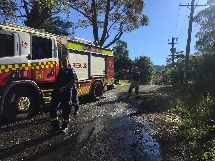 A Bulli Fire and Rescue NSW crew on the scene of Monday morning's shed fire at Wombarra. Picture: Adam McLean