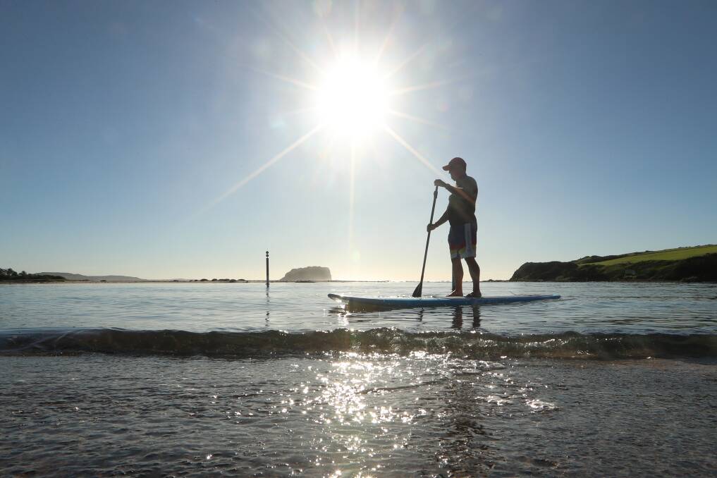 SUNNY DAYS: Greg Latimer paddleboards at Minnamurra. Partly cloudy weather and temps in the low-to-mid 20s are forecast this Easter long weekend. Picture: Sylvia Liber