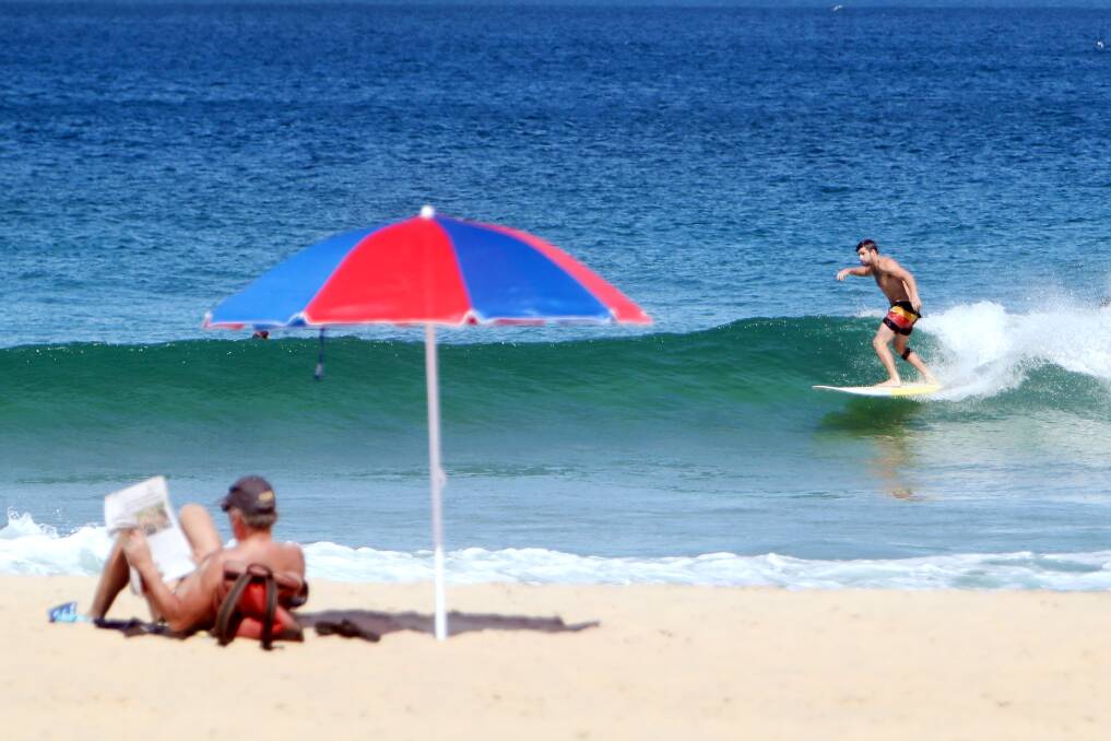 Beachgoers, both in and out of the water, enjoy sunny conditions at Wollongong's City beach on Friday. The beach is rated "very good". Picture: Sylvia Liber