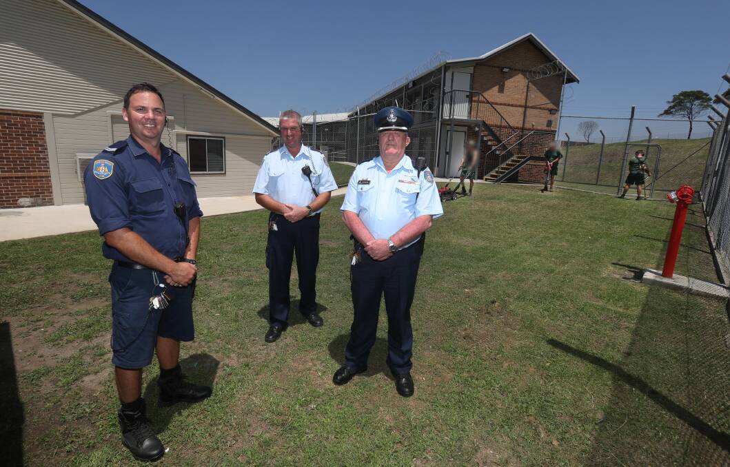 ON THE FRONT LINE: Corrective Services staff Peter Fitzgerald (overseer), Mark Gallagher (senior overseer) and Glenn Cochrane (acting manager of security) with inmates at Unanderra's Illawarra Reintegration Centre. Picture: Robert Peet