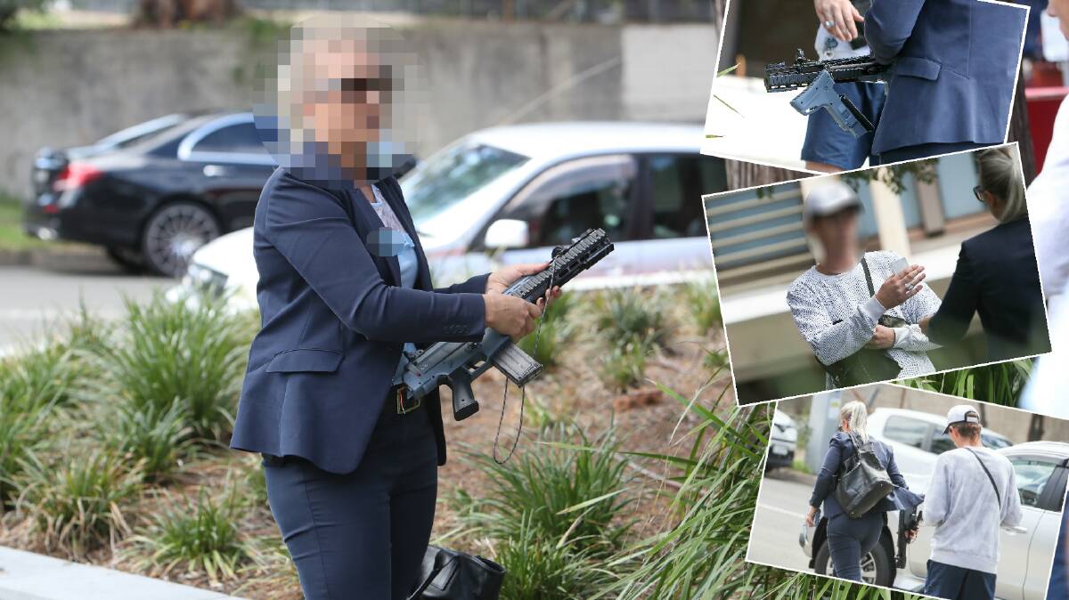 CAUGHT: A police officer checks the toy gun and speaks with the man who had it in his possession outside the city's court. Pictures: Adam McLean