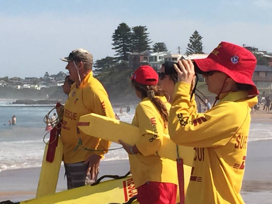 Volunteer lifesavers keep an eye on things during one of 22 rescues at Thirroul Beach on Monday. Picture: Ang Thompson.