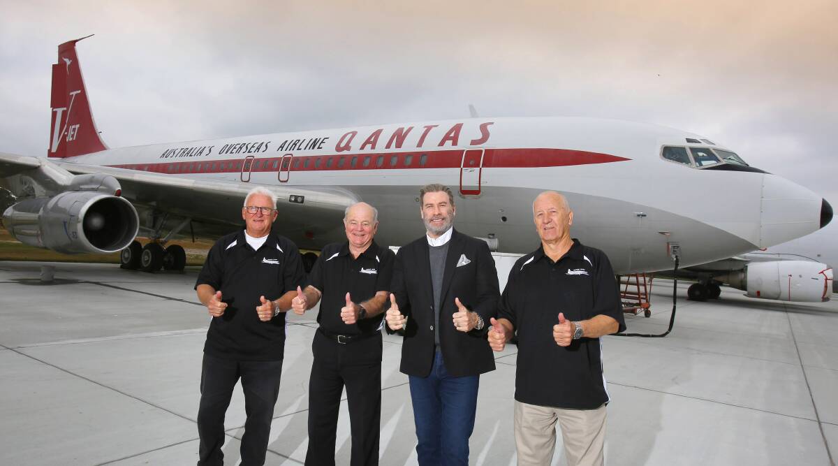 John Travolta officially hands over his Boeing 707 to HARS members Peter Elliott (left), John Dennis and Frank Bowden at Brunswick's Golden Isles Airport in Georgia USA on December 3. Picture: Andy Zakeli / www.lenswork.com.au