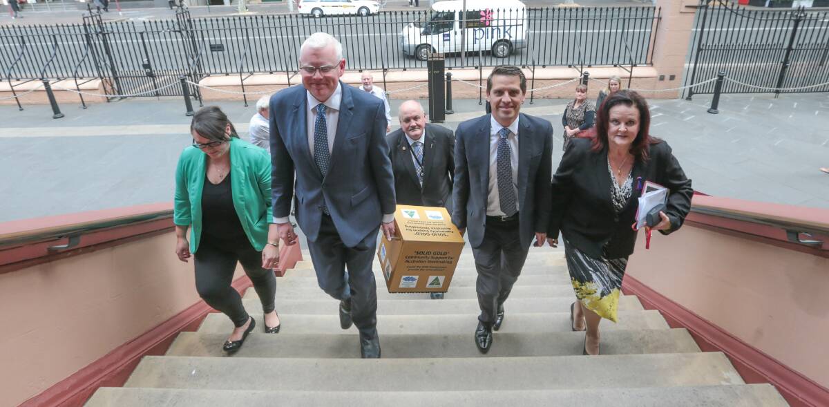 INCOMING: Noreen Hay's representative Susan Greenhalgh and Illawarra MPs Gareth Ward, Lee Evans, Ryan Park and Anna Watson take the petition into NSW Parliament.