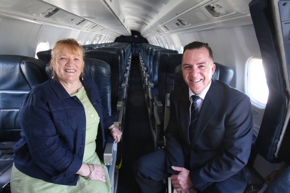 FLYING HIGH: Shellharbour mayor Marianne Saliba and Fly Corporate's Geoff Woodham inside the Saab 340B aircraft at Illawarra Regional Airport. Picture: Robert Peet