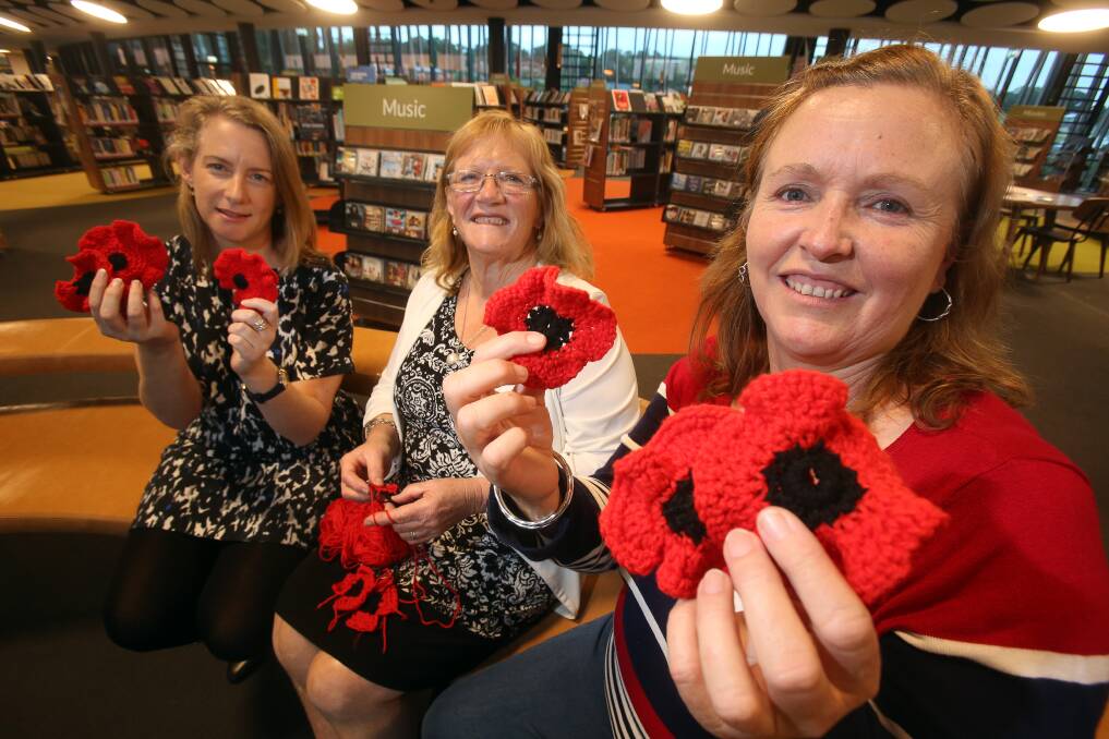 TRIBUTE: Sandra Huer (left) and Donna Brotherson (right) are off to Gallipoli with six handmade poppies. They are pictured with Shellharbour mayor Marianne Saliba, who helped create some of the 1000 flowers. Picture: Robert Peet
