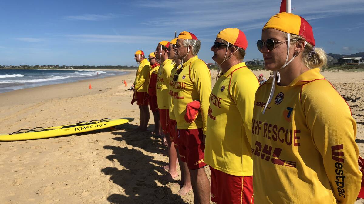 Lifesavers observe one minute's silence at Woonona on Monday, for two Victorian lifesavers who died on Sunday. Picture: Andrew Pearson