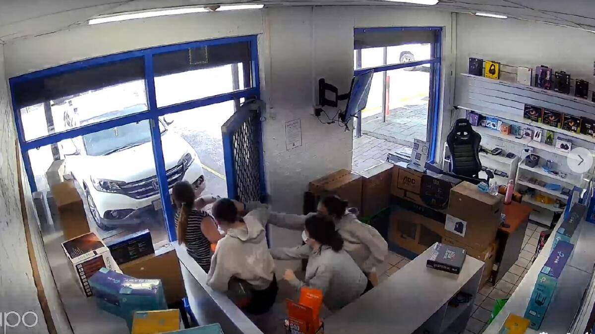 A still image from CCTV footage showing three females and a PCC Computers staff member (far left) in the Dapto store on Monday, March 11. Picture supplied