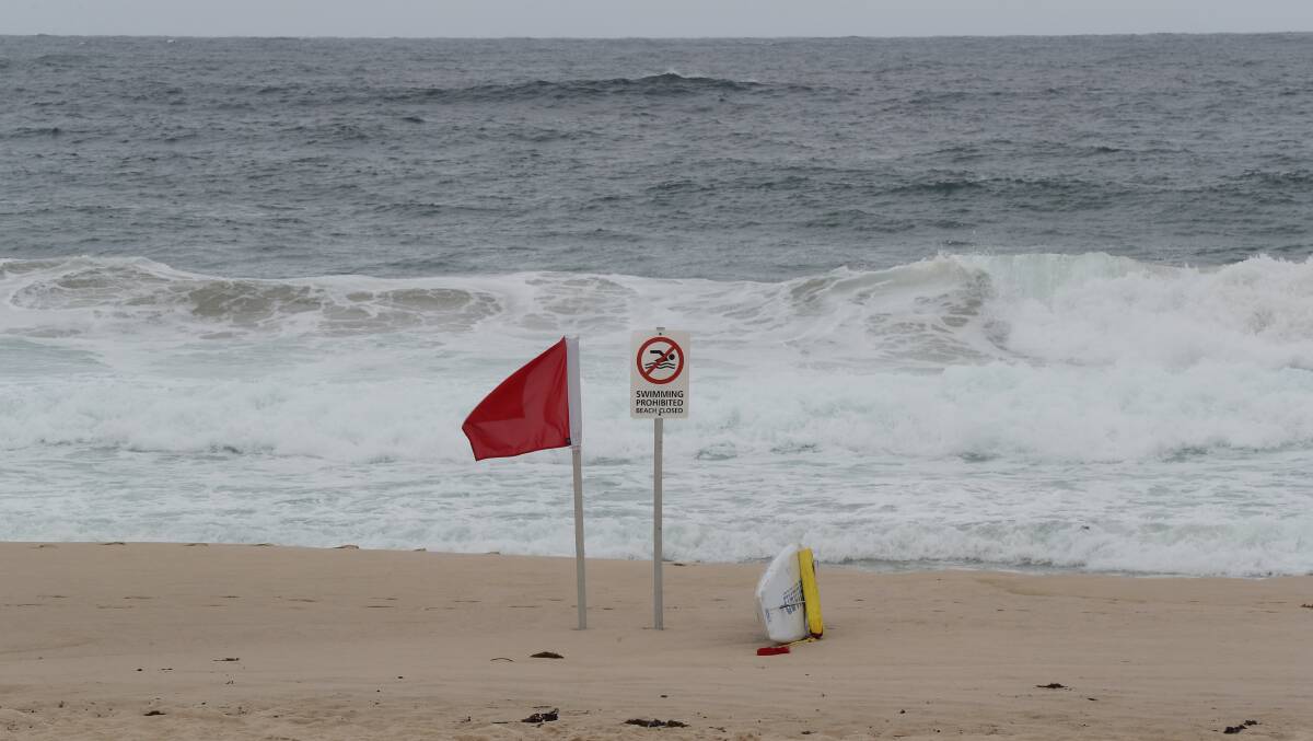 A beach closed sign on an Illawarra beach. Picture by Robert Peet