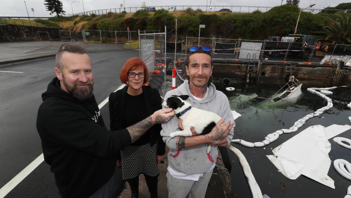 Barry Harrison Lancaster (on right) with his dog Tiberius, with Tristan Patterson and Debra Murphy, at the scene of where his boat sank on July 25. Picture by Robert Peet 