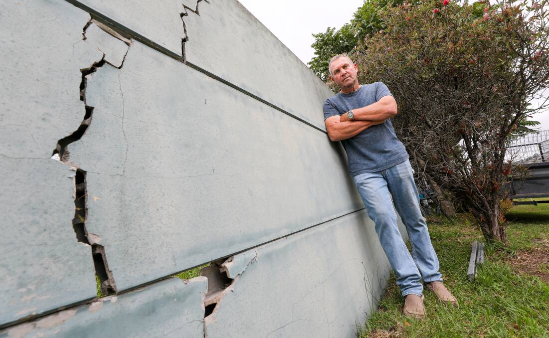 Paul Wheeler with the damaged acoustic fence at the rear of his home at Flinders. Picture by Adam McLean