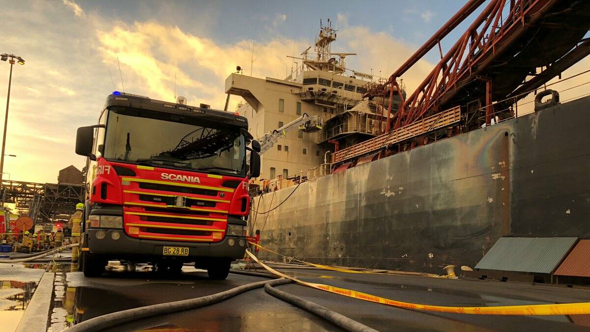 It took firefighters a week to get a fire on board the Iron Chieftain under control. Pictures by Robert Peet, Adam McLean, Wesley Lonergan, Fire and Rescue NSW