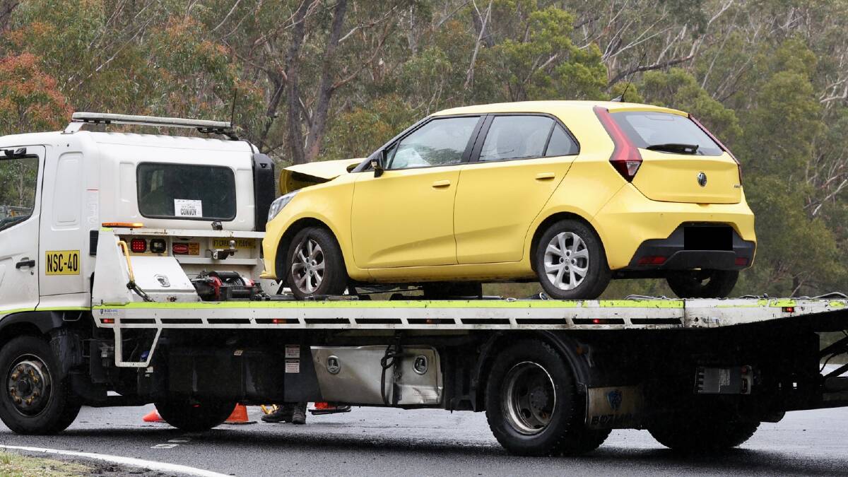 The yellow MG hatchback with front-end damage that was brought in behind police lines at the Mount Keira crash scene. Picture by Adam McLean 