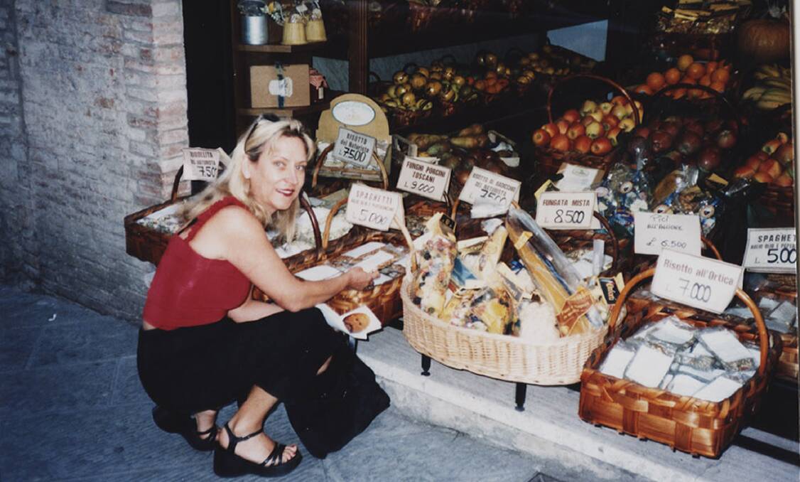 Monika Armstrong sampling fresh produce in Italy in 1999.