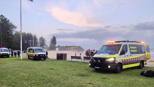 Swimmers being treated on Austinmer Beach after being rescued on December 11, 2023. Pictures by Sylvia Liber, Austinmer Surf Club