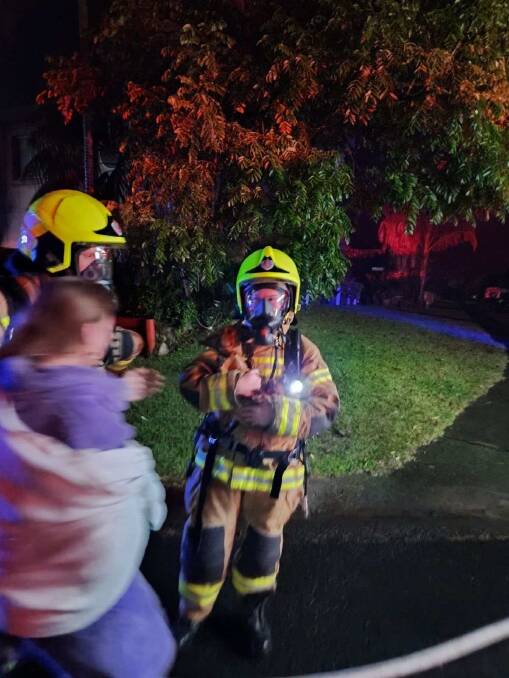 A firefighter with Scooby the miniature dachshund who was trapped inside a burning Kiama home on Tuesday, May 7, 2024. Picture supplied