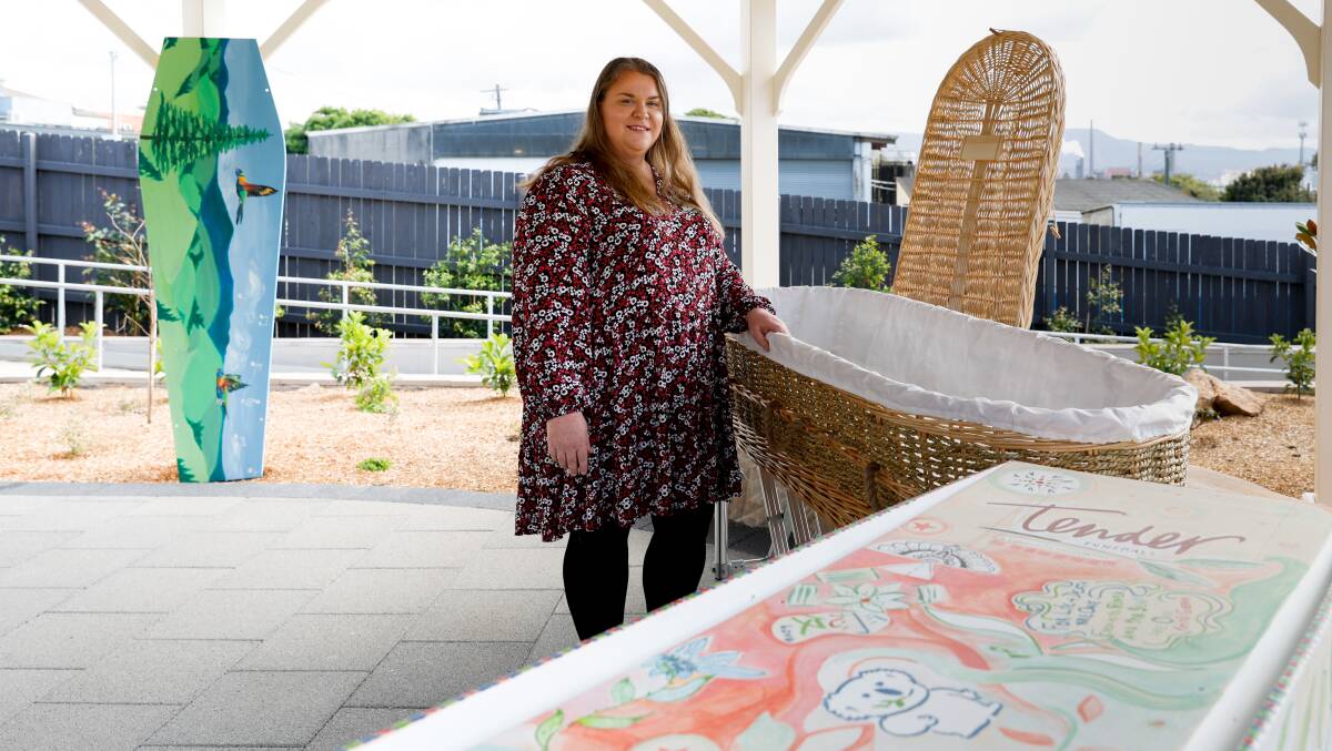 Funeral director Jade Kelly with a wicker coffin and some of the painted and decorated pine coffins. Picture by Anna Warr