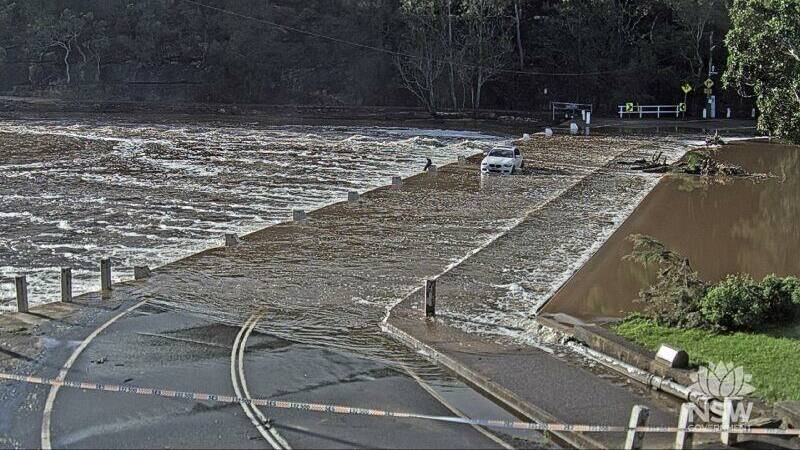 A car stuck in floodwaters on Audley Road at Audley Weir in the Royal National Park on Monday, May 6, 2024. Picture by Live Traffic