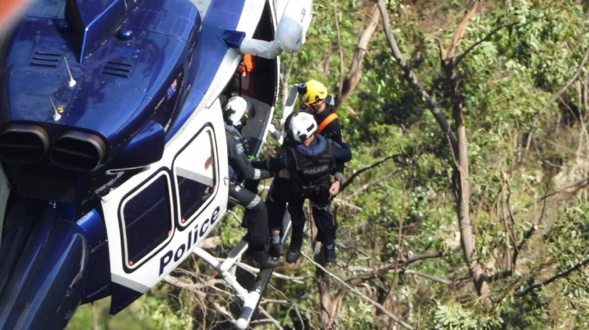 Rescuers searching for a missing woman who fell from a cliff at Belmore Falls on Sunday, April 8, 2024. Picture by Darren Malone