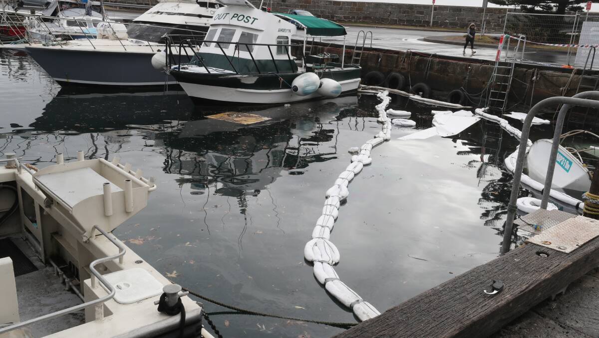 Fuel and debris are spilling out in Wollongong Harbour after a boat sand on July 25. Picture by Robert Peet