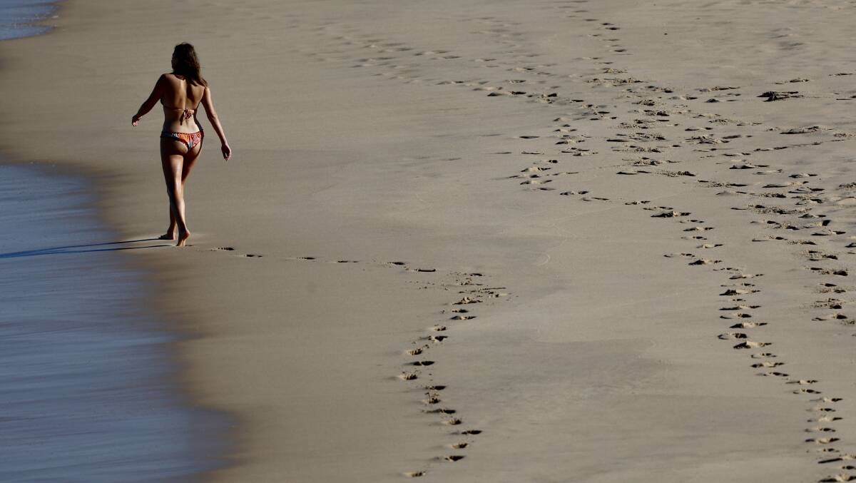 A woman strolling along City Beach on Wednesday, September 6. Picture by Adam McLean