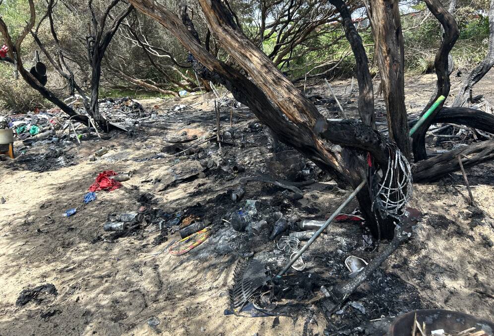 The charred remains after a fire tore through a make-shift camp in the sand dunes at City Beach, Wollongong on Thursday, December 14, 2023. Pictures by Nadine Morton 