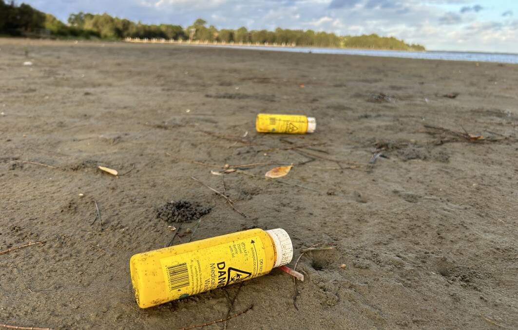 Syringes, sharps containers, swabs and medical waste were found along the Lake Illawarra waterline at Kanahooka on Thursday, March 21, 2024. Picture by Nadine Morton