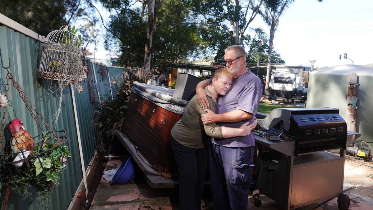 Leonie and Michael Whitton in their Albion Park Rail backyard which was flooded during the storm and heavy rain on Saturday, April 6, 2024. Picture by Sylvia Liber