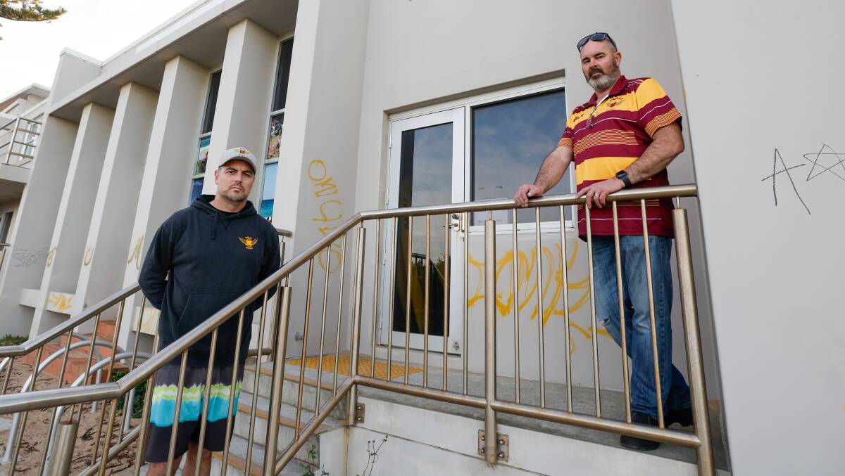 Bulli Surf Life Saving Club president Jamie Caldwell and vice president Lincoln Costello are angry that the volunteer's club was graffitied. Picture by Anna Warr