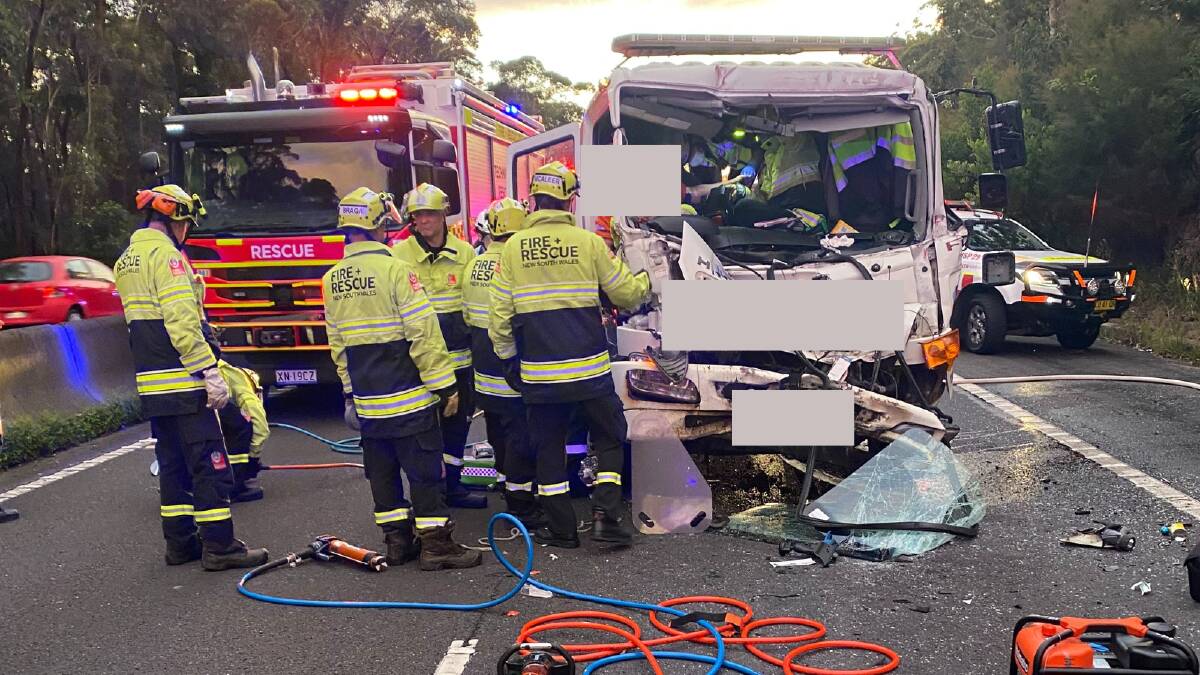 Emergency services assisting the injured truck driver on the M1 Princes Motorway at Bulli following a two-truck crash. Picture supplied