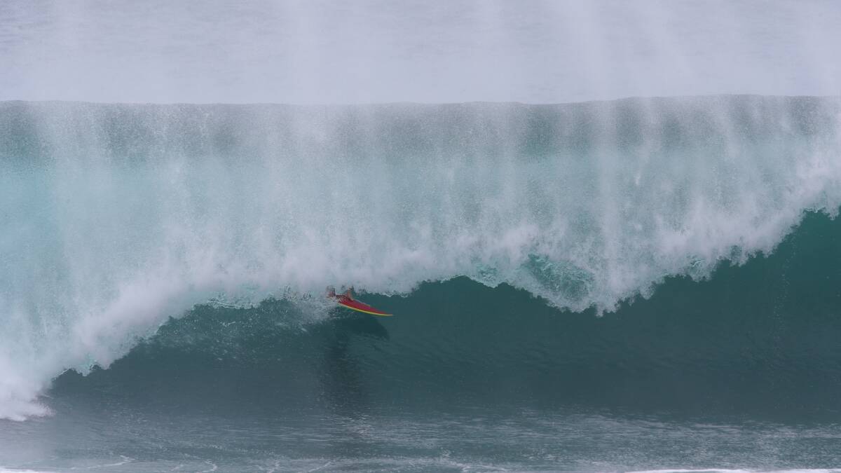 Surfers enjoying the huge 10-foot swell rolling into Shellharbour on Tuesday morning. Pictures by Sylvia Liber