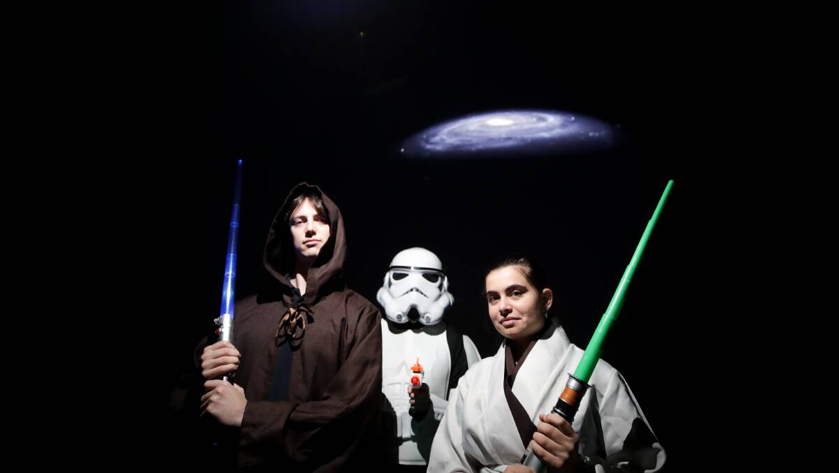 Come along, dress up and bring your lightsaber to the UOW Science Space on Friday to celebrate Stars Wars Day. Picture of Robby Marks, Charlotte Hawksley and Maycee Deszecsar by Adam McLean.