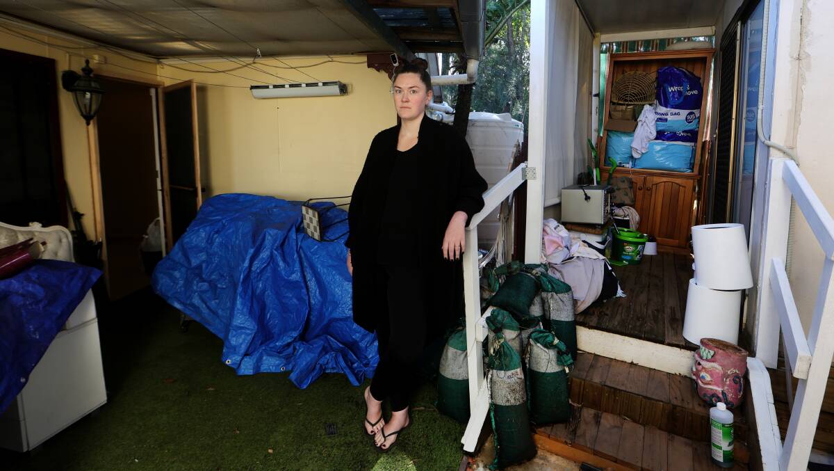 Jasmine Whitton in with her flood-damaged belongings and sandbags that were washed away from her Albion Park Rail home during the storm and heavy rain on Saturday, April 6, 2024. Picture by Sylvia Liber