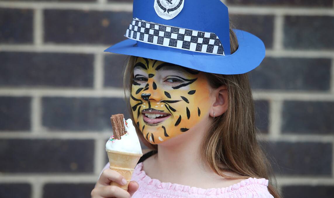 Chloe Lee, 9, eating icecream during Lake Illawarra Police District's open day on Saturday, March 25. Picture by Sylvia Liber