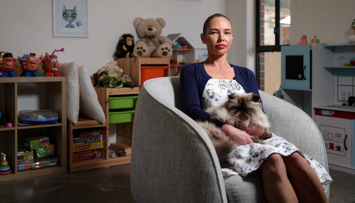 CONSTANT DEMAND: Psychologist Jaclyn Smoker sits in her Glenroy practice with Churchill the cat. "People are essentially putting off accessing the psychology services that they need and at the level of frequency that some of them actually need," she says. Picture: JAMES WILTSHIRE