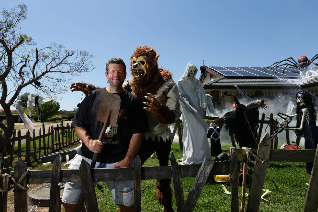 HAPPY HAUNTING: Steve Newberry has been transforming his front yard into a graveyard for the past five years to put a smile on neighbourhood faces. Picture: Jonathan Carroll.