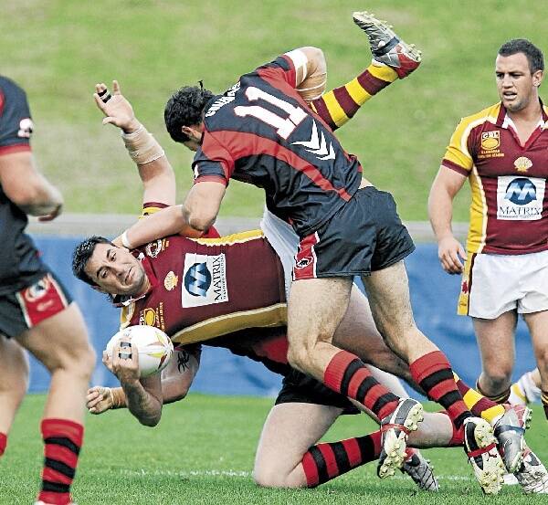 Collies' Rimini Reweti upends Nick Nikitaras of the Shellharbour Sharks during the Collegians 30-18 win at WIN Stadium yesterday. The Sharks only made the score look respectable in the last five minutes. Picture: KEN ROBERTSON