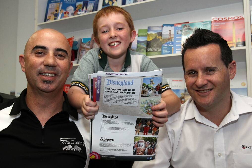 Hayden Veitch's wish to go to Disneyland has come true thanks to a fund-raiser organised by Figtree barber Nudge Mieli with the help of Figtree Travel's Craig Pearce. Picture: GREG TOTMAN