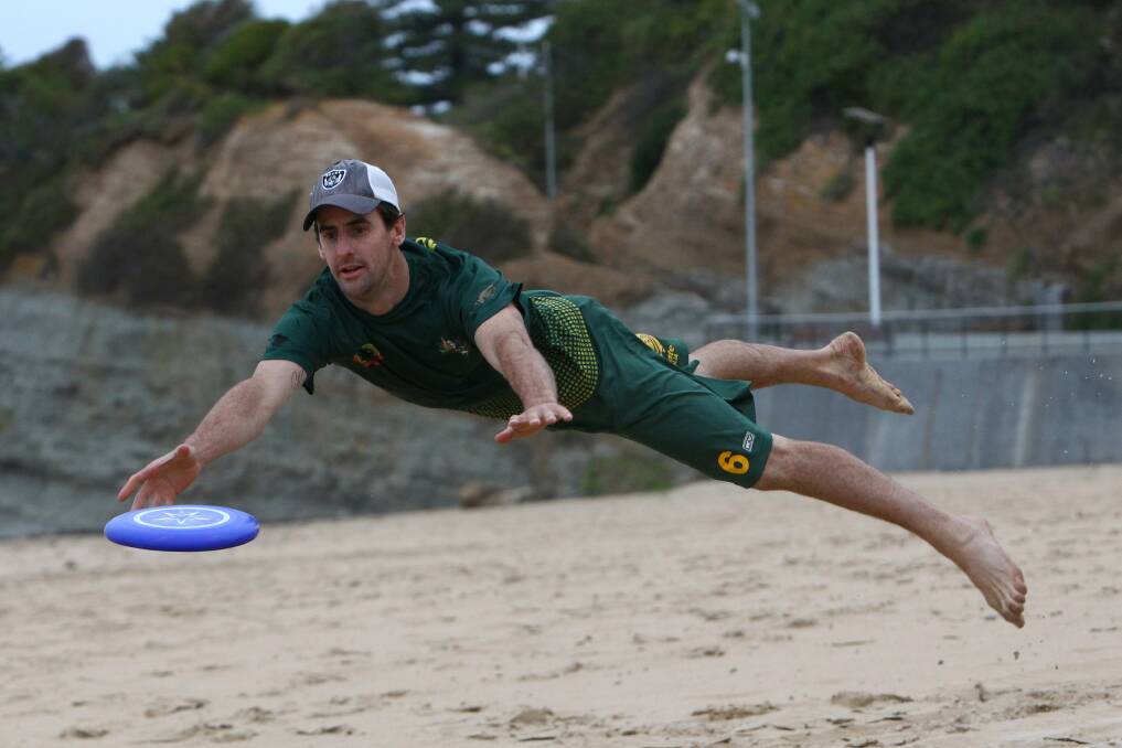 Tim Booth lunges for a frisbee in a game of Ultimate Frisbee at North Wollongong Beach. Picture: KEN ROBERTSON