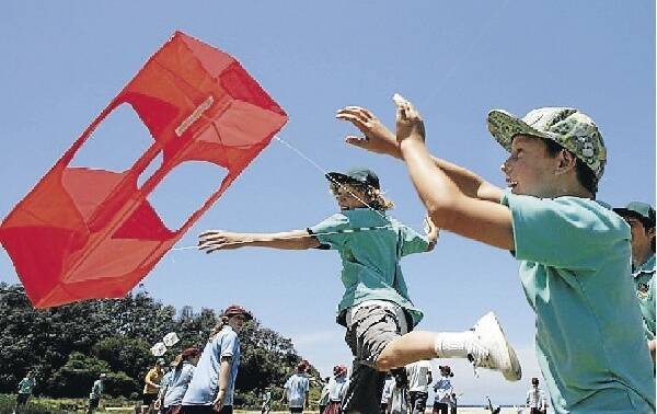 Helensburgh Public School students Regan McPherson, 12, (left) and Nathan Evans, 11, launch their box kite. Picture: ANDY ZAKELI