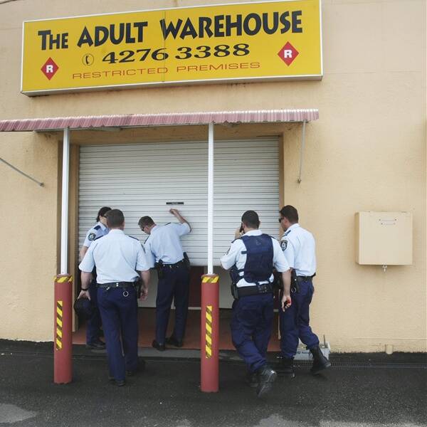 Police raid the Adult Central store at Albion Park, yesterday. Picture: ANDY ZAKELI