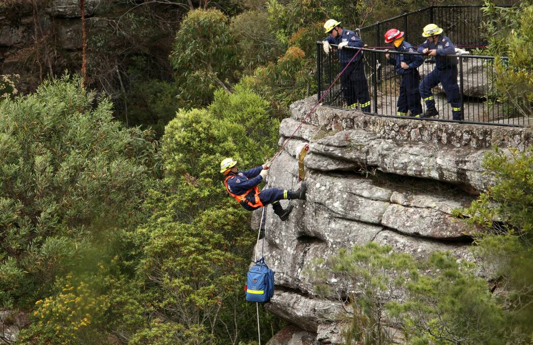 Richard Braga, a senior firefighter based at Bulli, is winched down to rescue Randy, the dummy patient.
