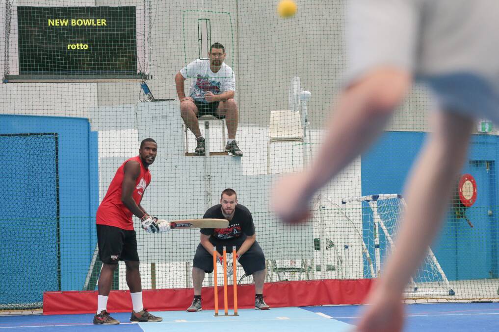 Hawks' US import Kevin Tiggs tries his hand at indoor cricket yesterday in North Wollongong. Picture: ADAM McLEAN