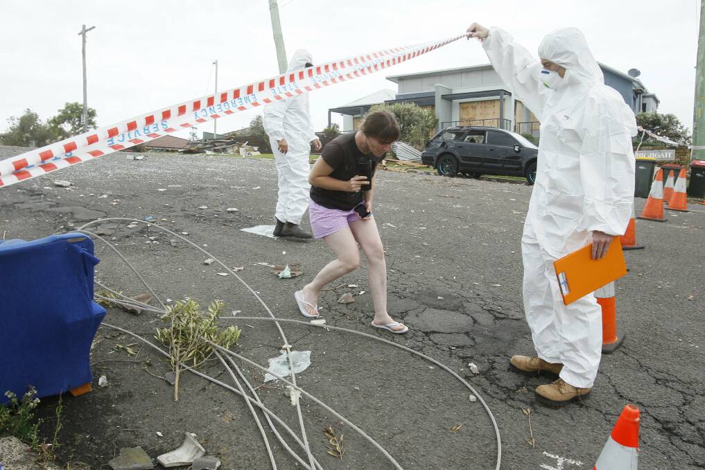 A resident leaves a cordoned-off street in Kiama. Picture:  DAVID TEASE