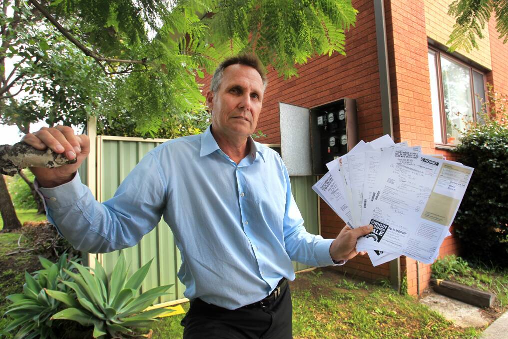 Real estate agent Charles Hegyi with the tenant's hefty power bill. Picture: ORLANDO CHIODO.