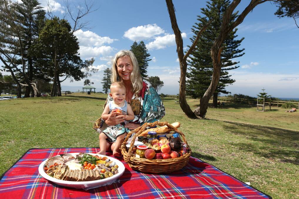 Monika Armstrong shares a picnic with one-year-old grandson Rio Morand at North Beach. Picture: ADAM McLEAN