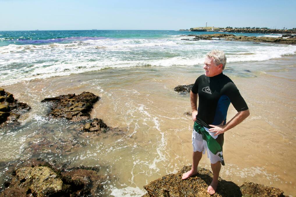 Dr Rob Brander puts purple dye in the water to help identify a rip at North Wollongong Beach. Picture: SYLVIA LIBER