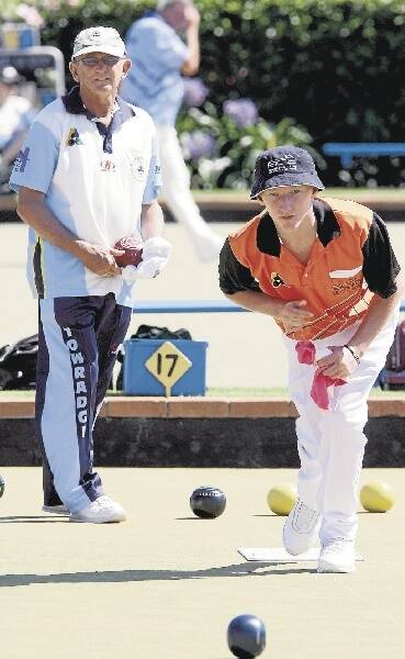 Ben Glasson, who teamed up with dad Steve, shows his winning style against Towradgi during yesterday's pairs action at Fairy Meadow Bowling Club. Picture: ANDY ZAKELI